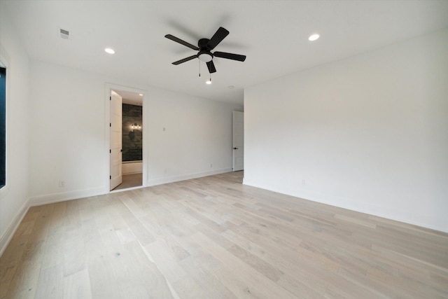 empty room with ceiling fan and light wood-type flooring