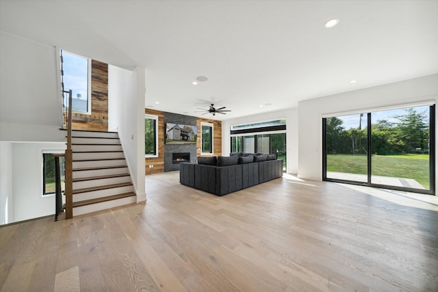 unfurnished living room with a wealth of natural light, a fireplace, and light wood-type flooring