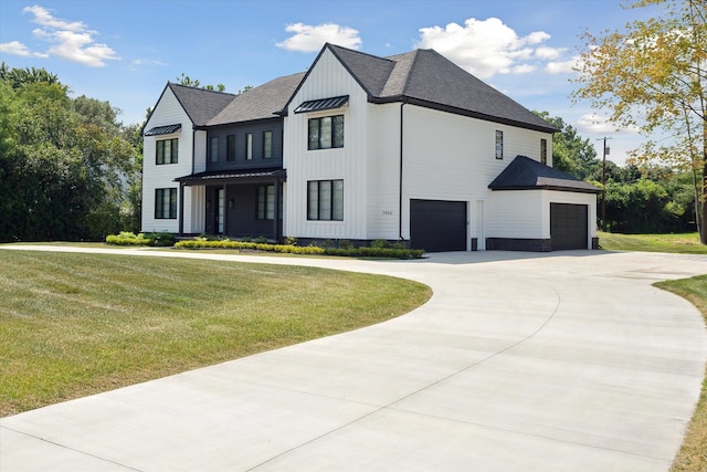 view of front of house featuring a garage and a front lawn