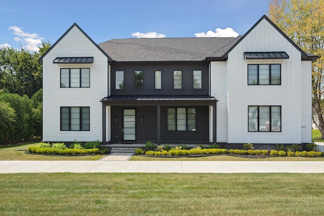 modern inspired farmhouse with a front lawn