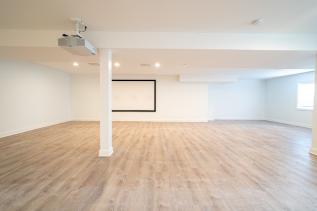 basement with light hardwood / wood-style flooring