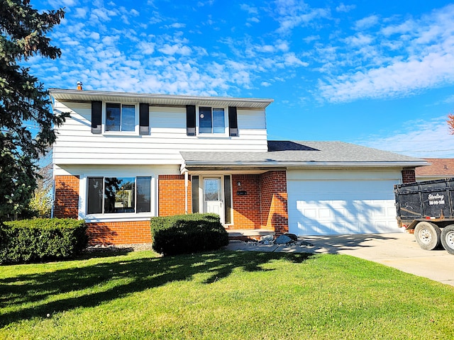 view of property with a garage and a front lawn