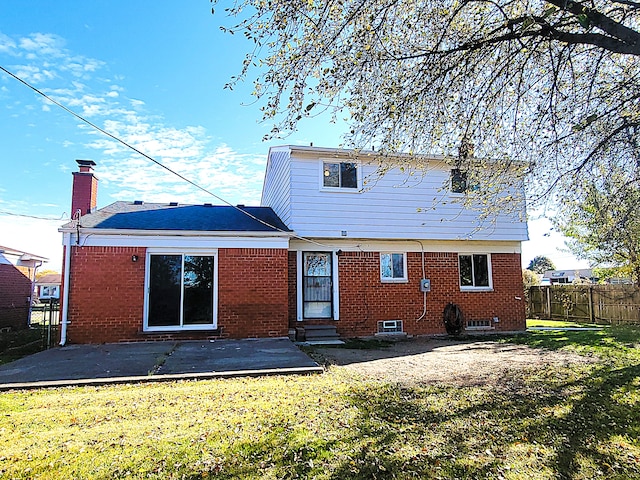 rear view of property with a lawn and a patio area