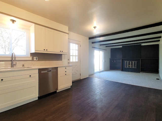 kitchen with white cabinets, sink, stainless steel dishwasher, dark hardwood / wood-style floors, and beam ceiling