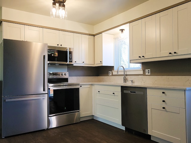 kitchen with white cabinets, stainless steel appliances, dark hardwood / wood-style floors, and sink