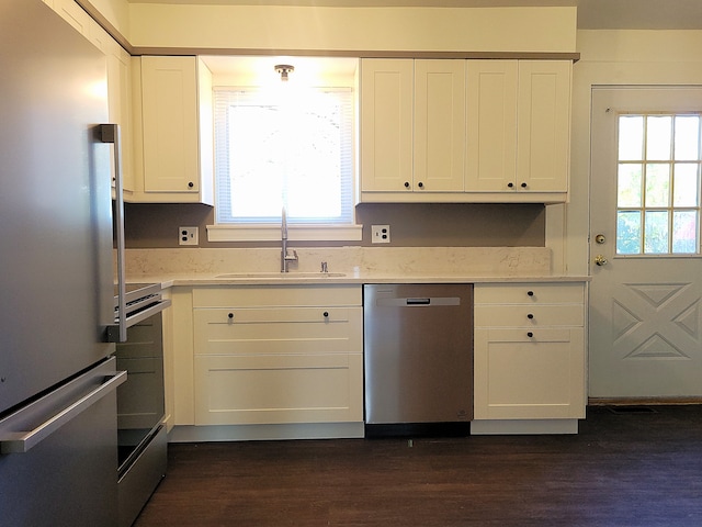 kitchen with white cabinetry, sink, stainless steel appliances, and plenty of natural light