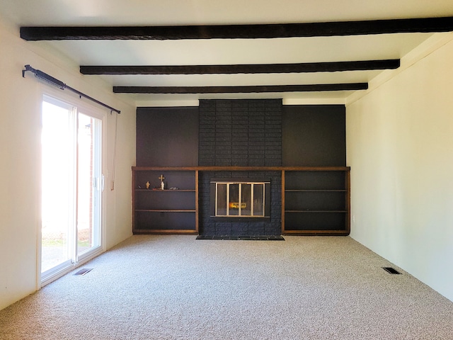 unfurnished living room with carpet flooring, a fireplace, and beamed ceiling