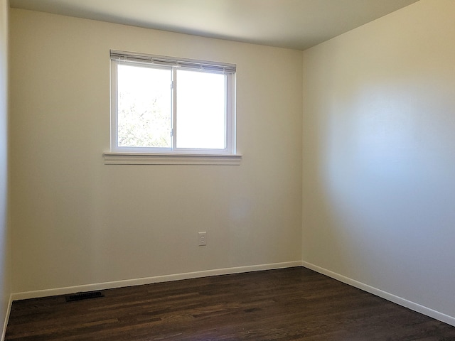 unfurnished room featuring dark hardwood / wood-style floors