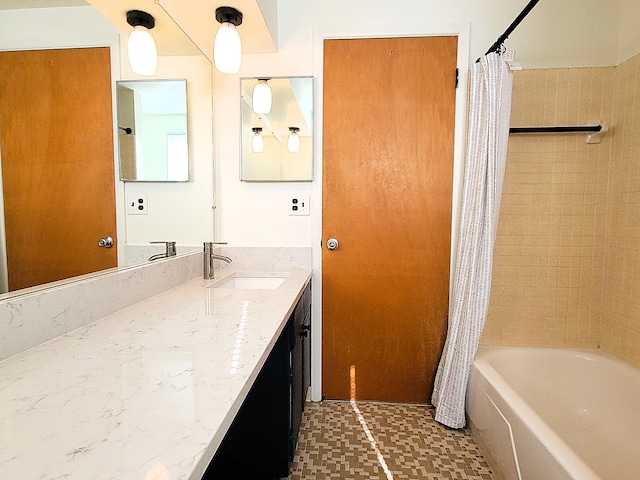 bathroom featuring shower / tub combo and vanity