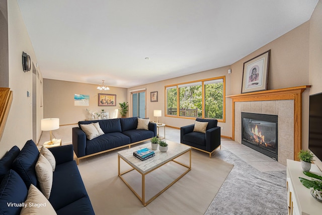 living room with a tile fireplace and a chandelier