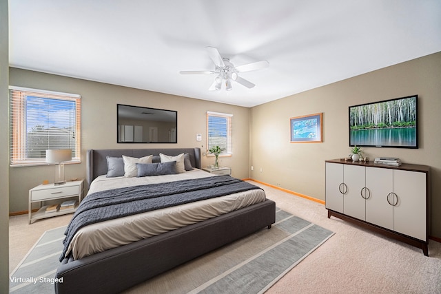 bedroom with light carpet and ceiling fan