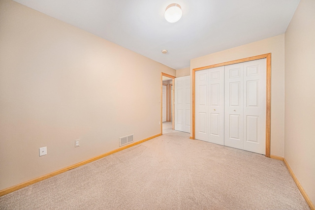 unfurnished bedroom featuring carpet floors and a closet