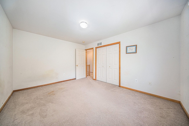 unfurnished bedroom with carpet floors and a closet