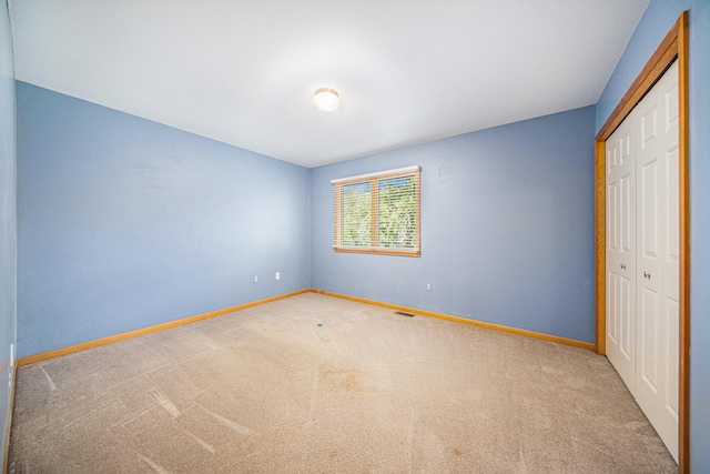 unfurnished bedroom featuring a closet and carpet