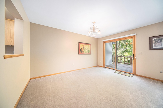 unfurnished room with a notable chandelier and light carpet