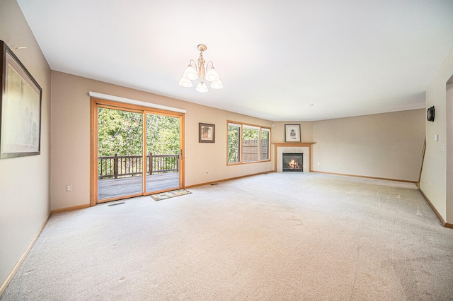 unfurnished living room with carpet floors and a chandelier