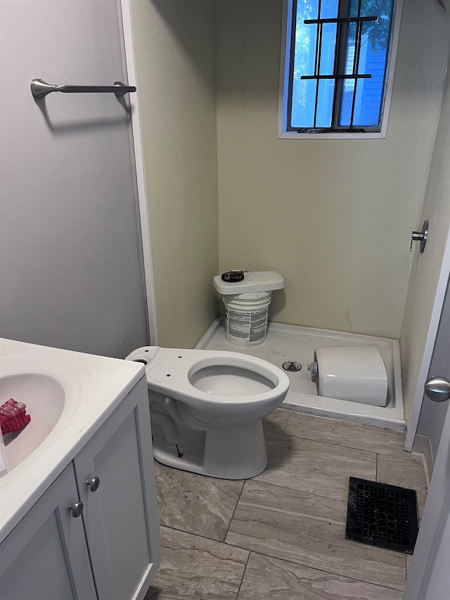 bathroom featuring vanity and toilet