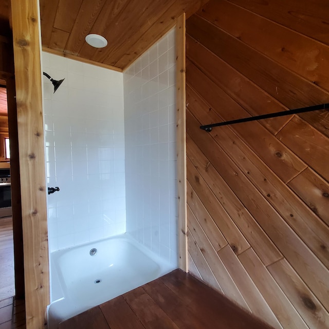 bathroom with wood ceiling and wooden walls