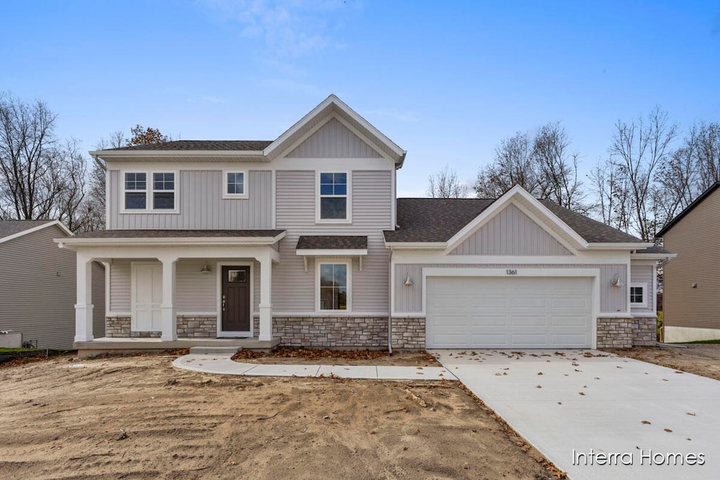 craftsman inspired home with covered porch and a garage