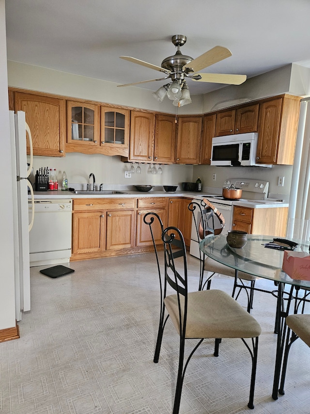 kitchen with ceiling fan, sink, and white appliances