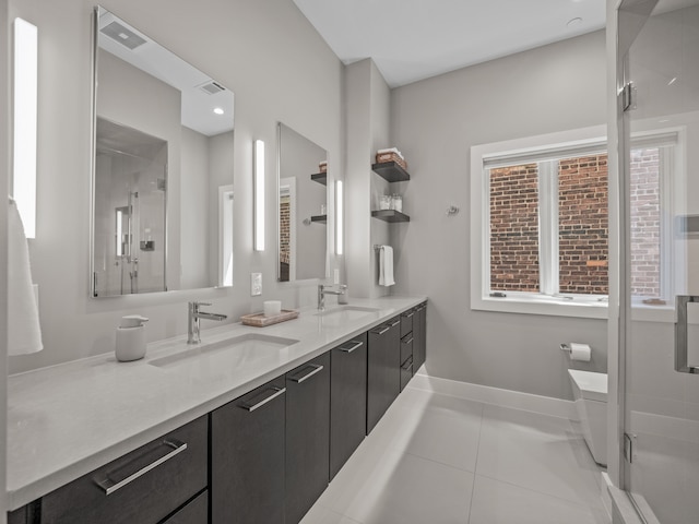 bathroom with tile patterned flooring, vanity, and walk in shower