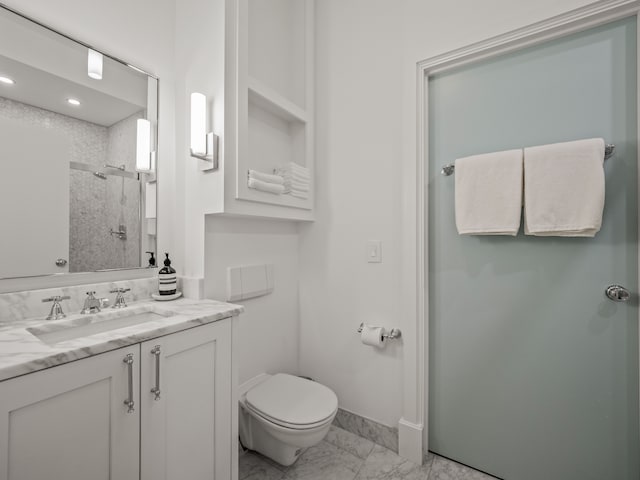 bathroom with vanity, toilet, and an enclosed shower