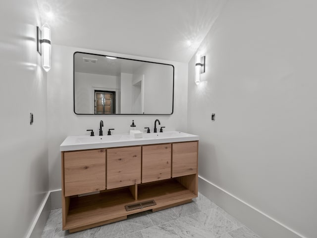 bathroom with vanity and vaulted ceiling