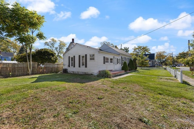 view of side of property with a lawn