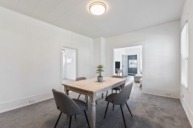 carpeted dining space with plenty of natural light