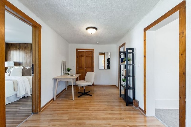 office with a textured ceiling and light hardwood / wood-style floors