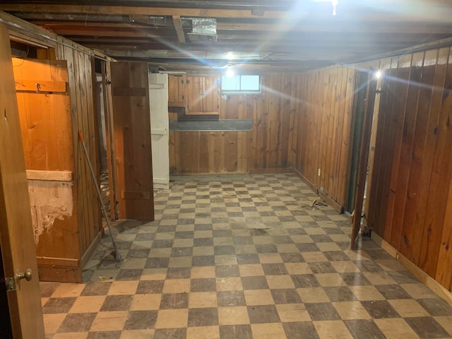 basement featuring wood walls