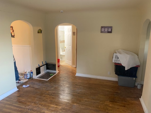 unfurnished living room with dark hardwood / wood-style floors