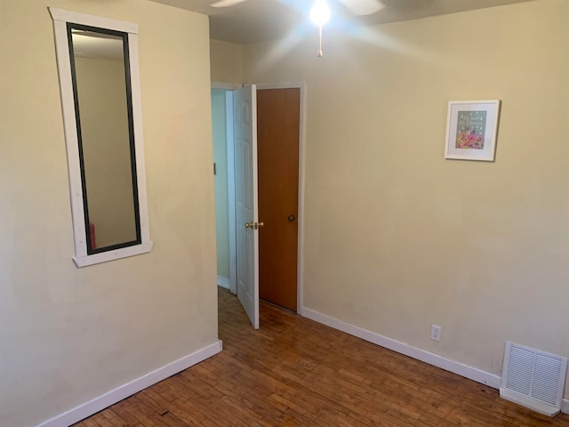 unfurnished room with hardwood / wood-style flooring and ceiling fan