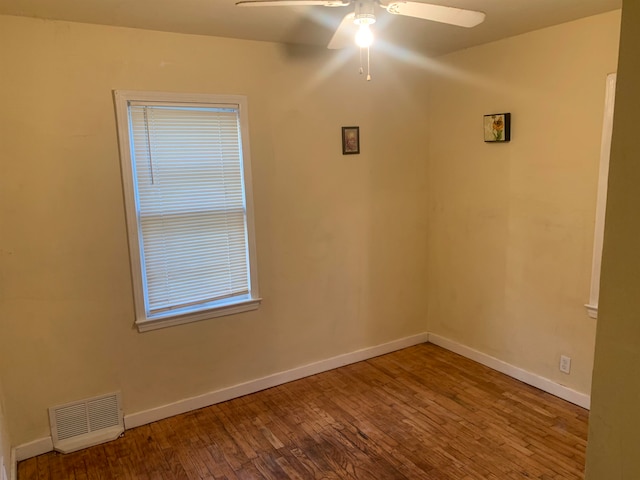 spare room featuring hardwood / wood-style flooring and ceiling fan