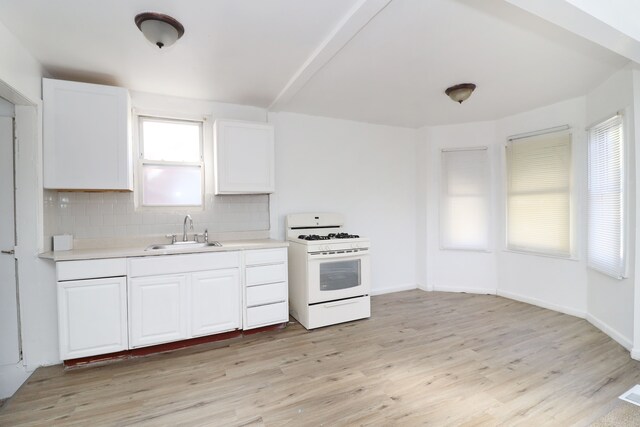 kitchen with white range with gas stovetop, light hardwood / wood-style flooring, plenty of natural light, and sink