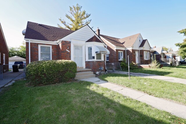 bungalow-style home with a front yard