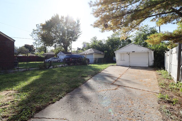 view of yard featuring an outbuilding and a garage