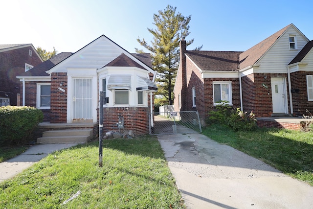 bungalow-style home with a front lawn