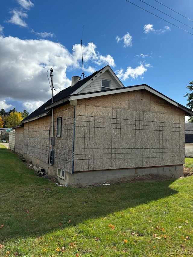 view of property exterior with a lawn