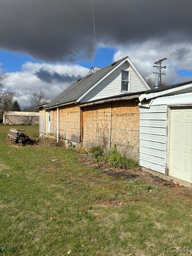 view of side of home featuring a lawn