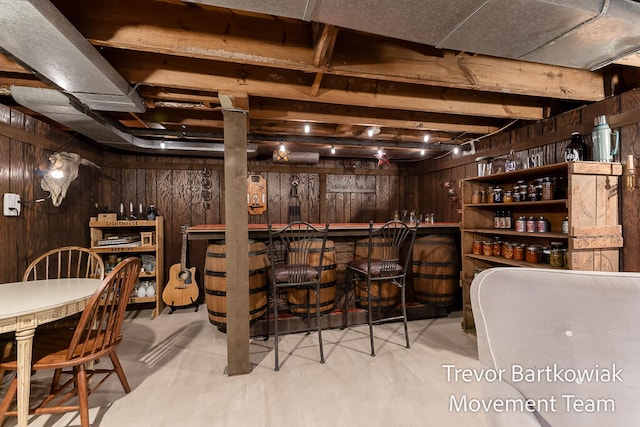 interior space with dark brown cabinets and wooden walls