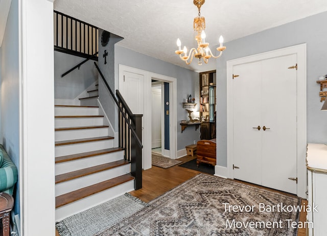 entryway featuring dark hardwood / wood-style floors and a chandelier