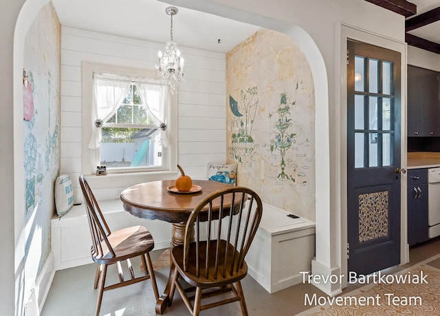 dining space featuring a wall mounted air conditioner and a notable chandelier