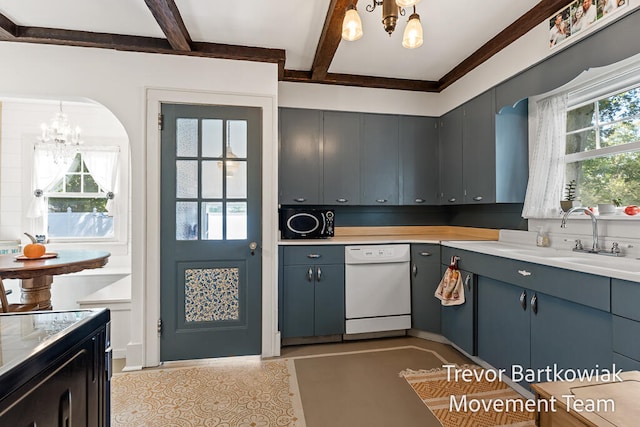 kitchen with a chandelier, sink, dishwasher, and a healthy amount of sunlight