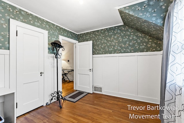 interior space featuring hardwood / wood-style floors and crown molding