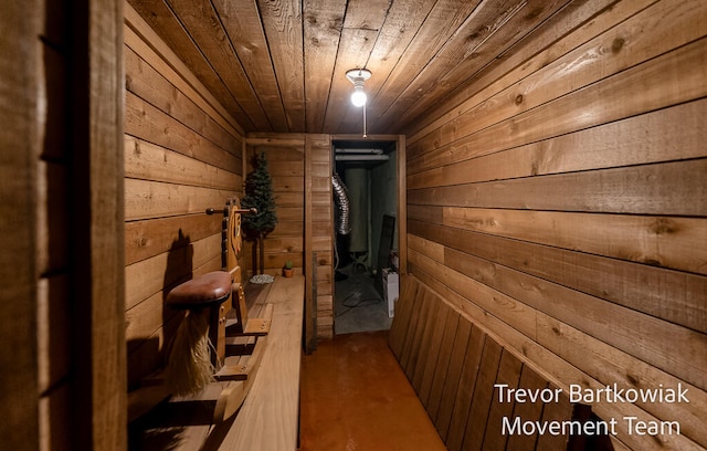 hallway featuring wood ceiling and wood walls