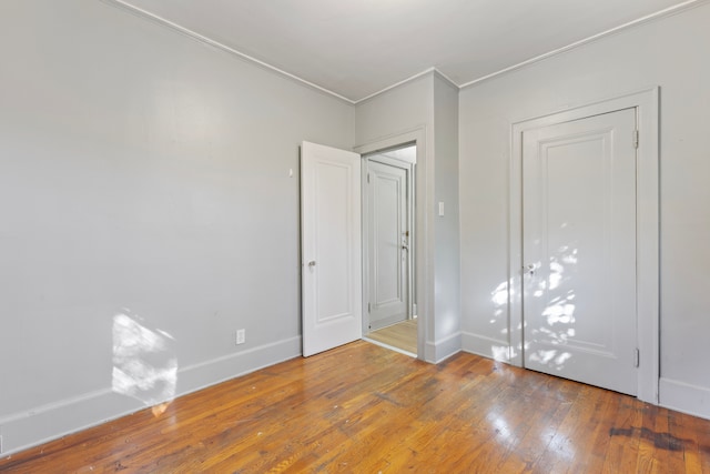 interior space with hardwood / wood-style flooring and ornamental molding