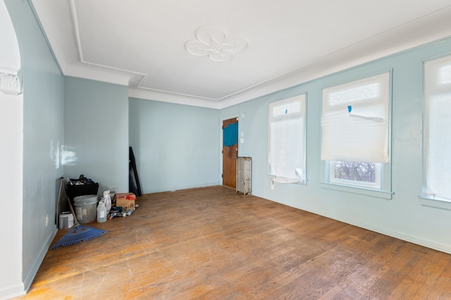 living room with radiator and light hardwood / wood-style flooring