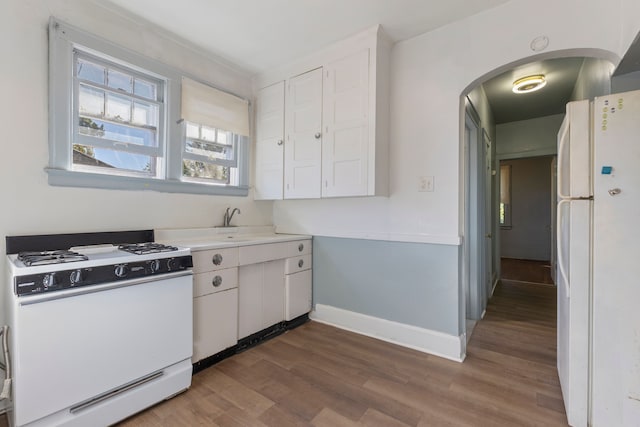 kitchen featuring white cabinetry, sink, dark wood-type flooring, and white appliances