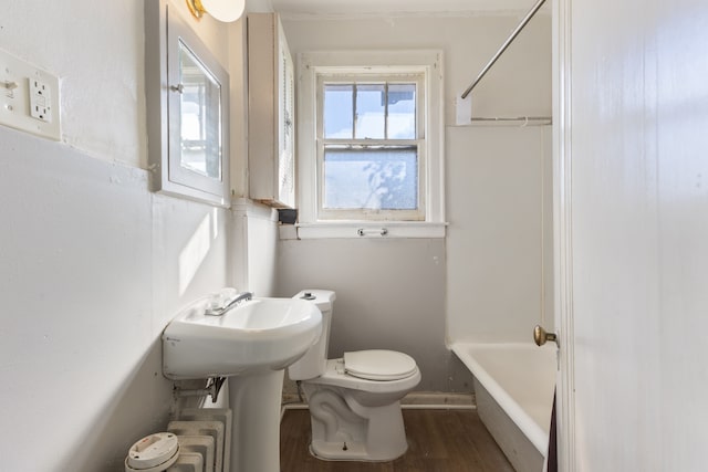 bathroom featuring toilet, tub / shower combination, and hardwood / wood-style flooring